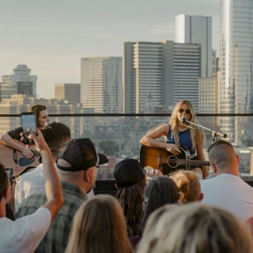 Live acoustic performance on the rooftop with skyline views